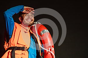 Lifeguard in life vest with ring buoy lifebuoy.