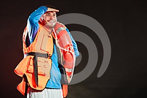 Lifeguard in life vest with ring buoy lifebuoy.