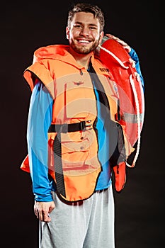 Lifeguard in life vest with ring buoy lifebuoy.