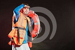 Lifeguard in life vest with ring buoy lifebuoy.