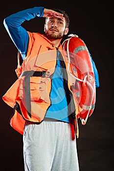 Lifeguard in life vest with ring buoy lifebuoy.