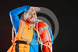 Lifeguard in life vest with ring buoy lifebuoy.