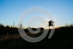 Lifeguard lookout post in silhouette photo