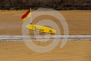 Lifeguard Paddle Board and Position Flag on a Coastal Beach
