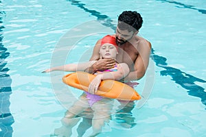 Lifeguard rescuing girl from swimming pool