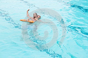 Lifeguard rescuing senior man from swimming pool