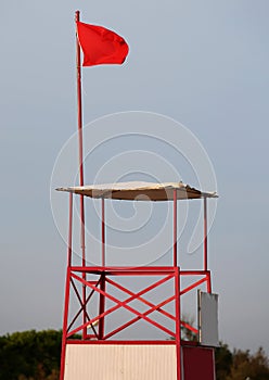 Lifeguard sighting tower in bathhouse with red flag