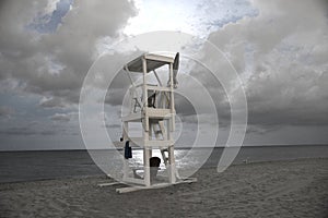 Lifeguard stand makes for a dramatic scene on the beach at midnight.