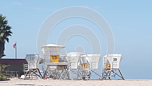 Lifeguard stand and palm tree, life guard tower for surfing on California beach.