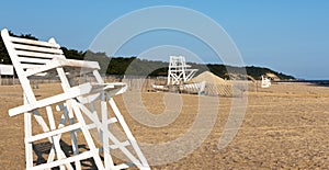 Lifeguard stands and a rescue boat on an empty beach