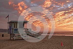 Lifeguard station with american flag on Hermosa beach at sunset