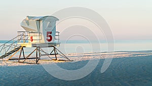 Lifeguard station on a beautiful white sand Florida beach with blue water.