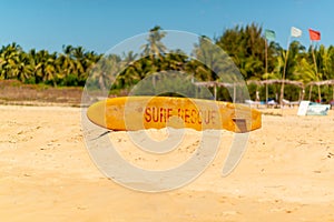 Lifeguard surfboard on sandy shore