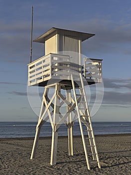 Lifeguard tower beach at sunrise with nobody