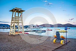 Lifeguard tower with beach wheel chair for disabled swimmers, Elounda, Crete