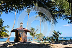 Lifeguard tower on the coconut beach. The clock tower, Hut or Cottage against the blue sky