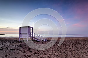 Lifeguard tower on the empty beach at sunrise in Puerto del Carmen