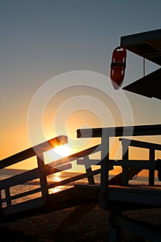 Lifeguard tower in front of a romantic sunset in santa monica beach