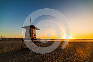 Lifeguard tower in Newport Beach shore at sunset