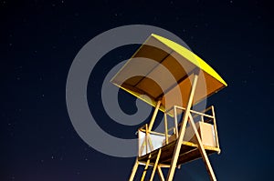 Lifeguard tower in the night with starry sky