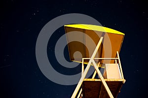 Lifeguard tower in the night with starry sky