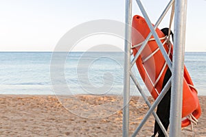 Lifeguard tower with orange buoy on the beach. rescue buoy on the iron rescue post