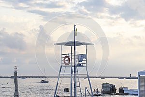 Lifeguard tower, resque post on the beach, plase where the lifegard sits and watch for the safety of swimming people