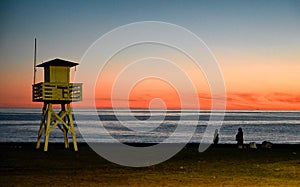 Lifeguard tower and sunset beach in the Mediterranean sea of Spain.