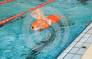 Lifeguard training with rescue dummy in a pool photo