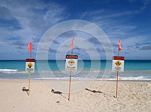 Lifeguard warnings signs place in sand on beach