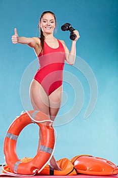 Lifeguard woman on duty with ring buoy lifebuoy.