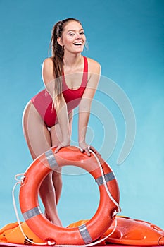 Lifeguard woman on duty with ring buoy lifebuoy.