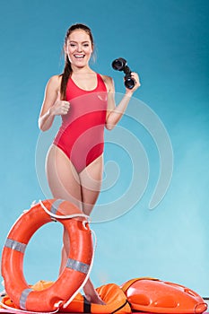 Lifeguard woman on duty with ring buoy lifebuoy.