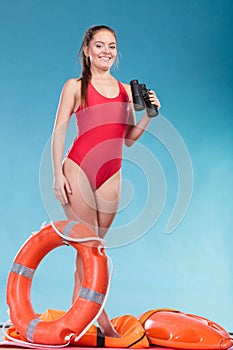 Lifeguard woman on duty with ring buoy lifebuoy.