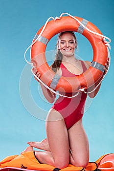 Lifeguard woman on duty with ring buoy lifebuoy.