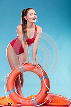 Lifeguard woman on duty with ring buoy lifebuoy.