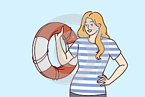 Lifeguard woman with lifebuoy guaranteeing safety of pool visitors or people relaxing on seashore
