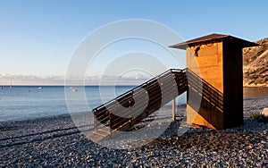 Lifeguard wooden tower at sunrise. Empty beach Pissouri Cyprus