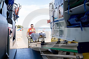 Lifeguard worker working on an ambulance on the beach