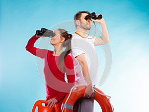 Lifeguards on duty looking through binoculars