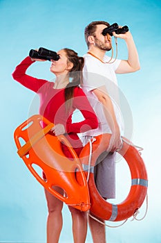 Lifeguards on duty looking through binoculars