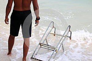 Lifeguards with ladders for long-tail boat on the beach