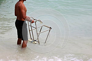 Lifeguards with ladders for long-tail boat on the beach.