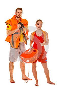 Lifeguards in life vest with rescue buoy.