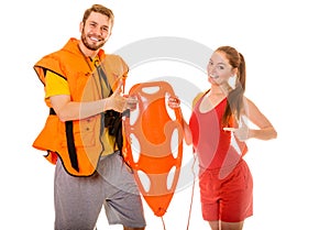 Lifeguards in life vest with rescue buoy.