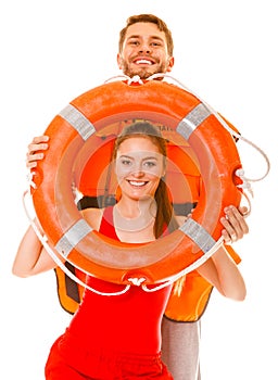 Lifeguards in life vest with ring buoy having fun.