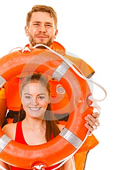 Lifeguards in life vest with ring buoy having fun.