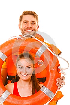 Lifeguards in life vest with ring buoy having fun.