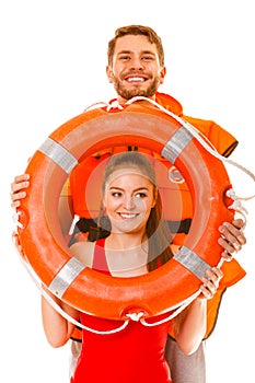 Lifeguards in life vest with ring buoy having fun.