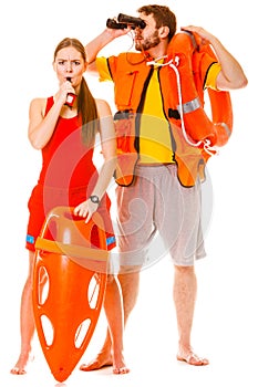 Lifeguards in life vest with ring buoy whistling.